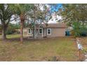Newly renovated house with teal front door, and a porch at 13 E 8Th St, Frostproof, FL 33843