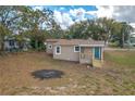 Newly renovated house with teal front door, and a porch at 13 E 8Th St, Frostproof, FL 33843