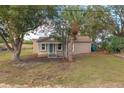 Newly renovated house with teal front door, and a porch at 13 E 8Th St, Frostproof, FL 33843