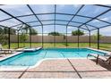 Screened pool and spa with lounge chairs; perfect for relaxation at 1502 Moon Valley Dr, Davenport, FL 33896