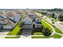 Aerial view of a two-story house in a residential neighborhood at 9098 Hazard St, Davenport, FL 33896