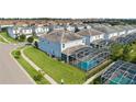 Aerial view showcasing a home with a private screened pool and surrounding neighborhood at 9098 Hazard St, Davenport, FL 33896