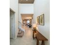 Bright and airy entryway with staircase and console table at 8909 Bengal Ct, Kissimmee, FL 34747