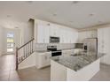 Spacious kitchen with granite island and stainless steel appliances at 1688 Tropical Palms Cir, Kissimmee, FL 34747