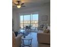 Bright living room with balcony access and lake view at 1097 Splash Shot # 1097, Davenport, FL 33896