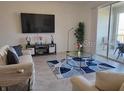 Bright living room with large TV and access to balcony at 1097 Splash Shot # 1097, Davenport, FL 33896