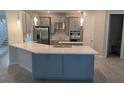 Spacious kitchen with large island and white countertops at 3937 Reed Grass Pl, Kissimmee, FL 34746
