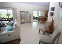 Bright living room with tile floors and access to a patio at 13900 Fox Glove St, Winter Garden, FL 34787