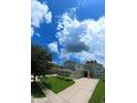 Two-story house with a three car garage and manicured lawn at 13900 Fox Glove St, Winter Garden, FL 34787