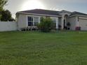 One story home with a two car garage and a landscaped lawn at 924 Derbyshire Dr, Kissimmee, FL 34758