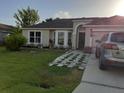 One story home with a two car garage and a landscaped lawn at 924 Derbyshire Dr, Kissimmee, FL 34758