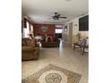 Open living and dining area with tiled floors and a large screen TV at 662 Rosselli Blvd, Davenport, FL 33896