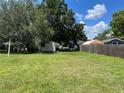 Spacious backyard with grassy area and wooden fence at 1323 Kory St, Kissimmee, FL 34741