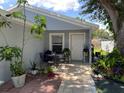 Inviting patio with seating area, lush plants, and brick pavers at 1323 Kory St, Kissimmee, FL 34741