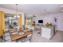 Open concept kitchen and living area with modern finishes at 8982 Stinger Dr, Champions Gate, FL 33896