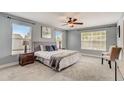 Large bedroom with carpeted floor and ceiling fan at 6943 Cupseed Ln, Harmony, FL 34773