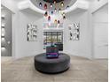 Elegant entryway with a circular bench and unique lighting at 350 Muirfield Loop, Reunion, FL 34747