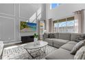 Spacious living room with sectional sofa, large TV, and high ceilings at 9119 Sommerset Hills Dr, Davenport, FL 33896