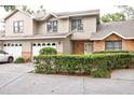 Two-story townhome with a landscaped front yard and two-car garage at 1019 Monroe Ave, Saint Cloud, FL 34769