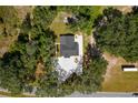 Aerial view of a house with a large backyard and a paved driveway at 8941 E County Road 466, The Villages, FL 32162
