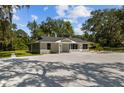 Newly renovated house with gray exterior and large windows at 8941 E County Road 466, The Villages, FL 32162