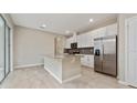 Open kitchen island with granite countertops and stainless steel appliances at 5879 Soter Ln, Windermere, FL 34786