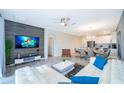 Open concept living room with modern furniture and kitchen view at 785 Ocean Course Ave # 785, Davenport, FL 33896