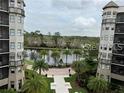 Apartment building with a scenic view of the lake and lush landscaping at 14501 Grove Resort Ave # 1535, Winter Garden, FL 34787