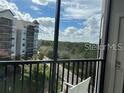 View from a condo balcony overlooking trees and a residential area at 14501 Grove Resort Ave # 3535, Winter Garden, FL 34787