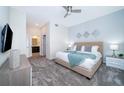 Main bedroom with king-size bed, TV, and access to bathroom at 1193 Drop Ln # 1193, Davenport, FL 33896