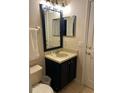 Vanity with sink, mirror and dark blue cabinetry at 718 Verona Ave, Davenport, FL 33897