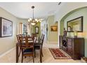 Spacious dining area with a granite-topped table and hardwood floors at 384 Grand Canal Dr, Poinciana, FL 34759