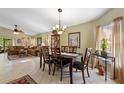 Bright dining room with seating for six and a view of the living area at 384 Grand Canal Dr, Poinciana, FL 34759