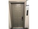 Gray apartment entry door with keyless entry at 14501 Grove Resort Ave # 1318, Winter Garden, FL 34787