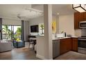 Open kitchen and living area with modern appliances at 14501 Grove Resort Ave # 1318, Winter Garden, FL 34787