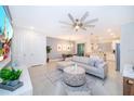Spacious living room with open floor plan, large TV, and comfy couch at 1852 Tropical Palms Cir, Kissimmee, FL 34747