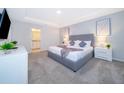 Bright and airy main bedroom with a comfortable bed and ensuite bathroom at 1852 Tropical Palms Cir, Kissimmee, FL 34747