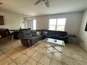 Spacious living room with sectional sofa and tile floors at 8581 Rindge Rd, Polk City, FL 33868