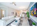 Open living room with white sectional sofa and adjacent dining area at 769 Ocean Course Ave # 769, Davenport, FL 33896