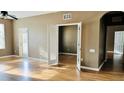 Open living room with hardwood floors and access to balcony at 3338 Robert Trent Jones Dr # 20904, Orlando, FL 32835