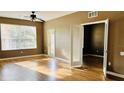 Spacious living room with hardwood floors and French doors at 3338 Robert Trent Jones Dr # 20904, Orlando, FL 32835
