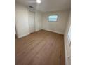 Bright bedroom featuring light wood laminate flooring at 1565 Channell Dr, Mount Dora, FL 32757