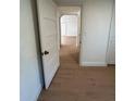 Long hallway with light wood laminate flooring at 1565 Channell Dr, Mount Dora, FL 32757