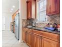 Kitchen with stainless steel appliances and wood cabinets at 1134 Tapestry Dr, Celebration, FL 34747