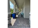 Covered porch with stone columns, blue planters, and seating at 3253 Wauseon Dr, Saint Cloud, FL 34772