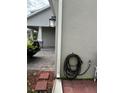 Home's exterior showing landscaping, a hose, and a light fixture at 3253 Wauseon Dr, Saint Cloud, FL 34772