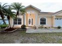 Front entry of a one-story house with a covered porch and landscaping at 4221 Settlers Ct, Saint Cloud, FL 34772