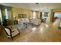 Spacious living room with light beige tile floors and large windows at 301 Las Fuentes Dr, Kissimmee, FL 34746