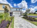 Two-story townhome with attached garage and landscaping at 7901 Putting Green Way, Reunion, FL 34747