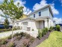Two-story townhome with attached garage and landscaping at 7901 Putting Green Way, Reunion, FL 34747